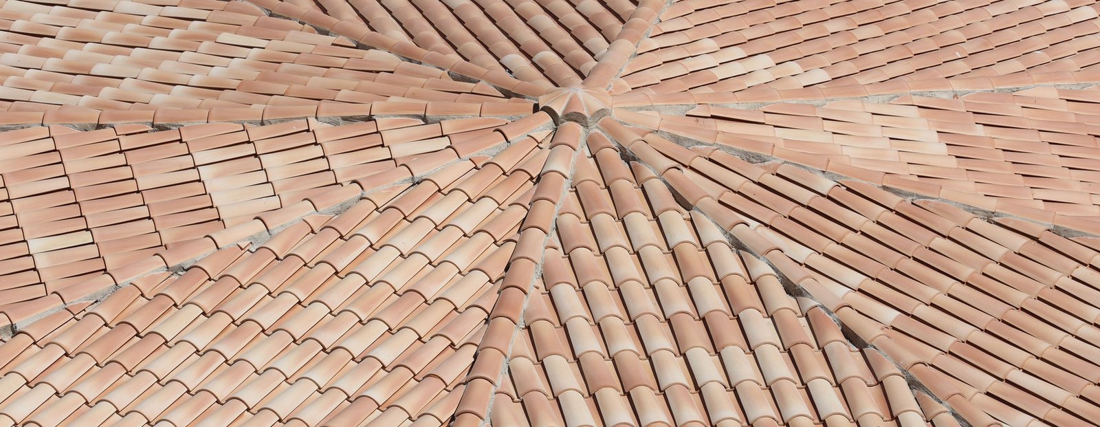 Clay tile courses radiating from a four-hip convergence