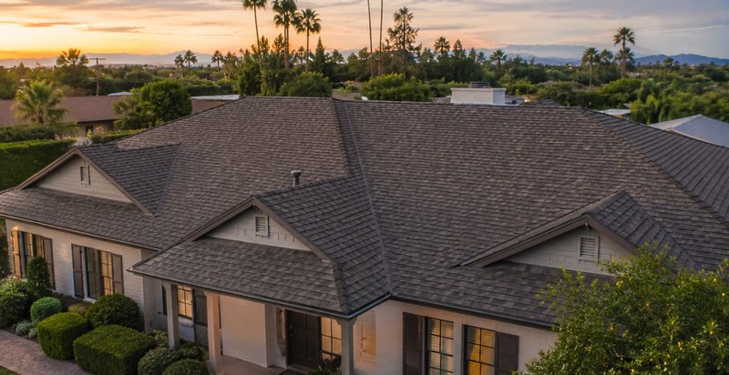Architectural asphalt shingles laid in courses on a roof deck