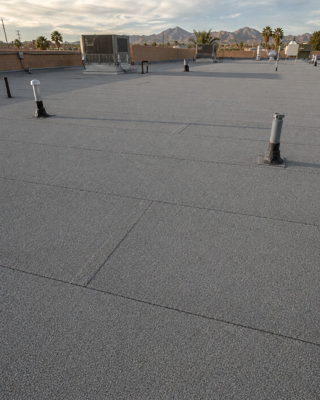 The same commercial roof after full replacement with a new granulated cap sheet