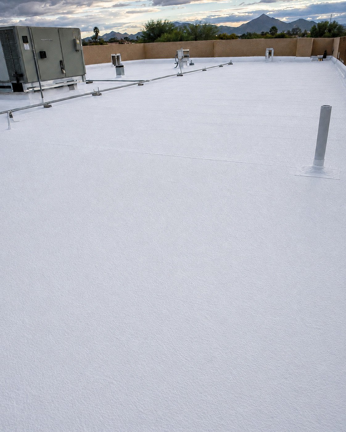 The same foam roof after restoration, coated smooth and uniformly white
