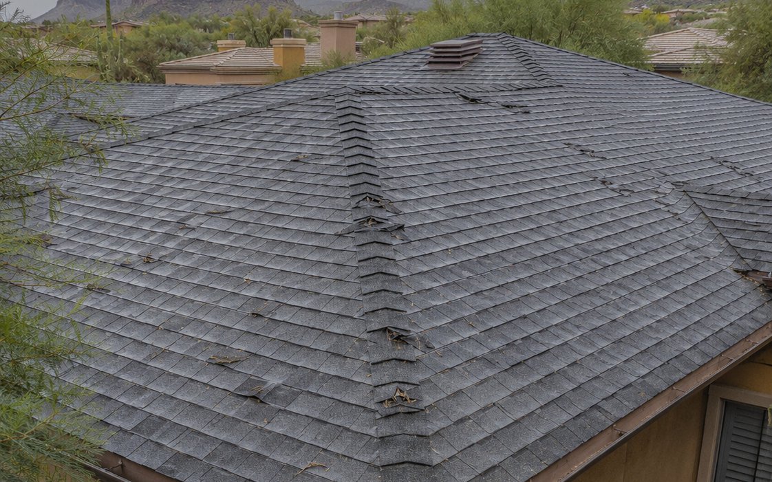 Chalked test square on a roof showing measured hail impact marks