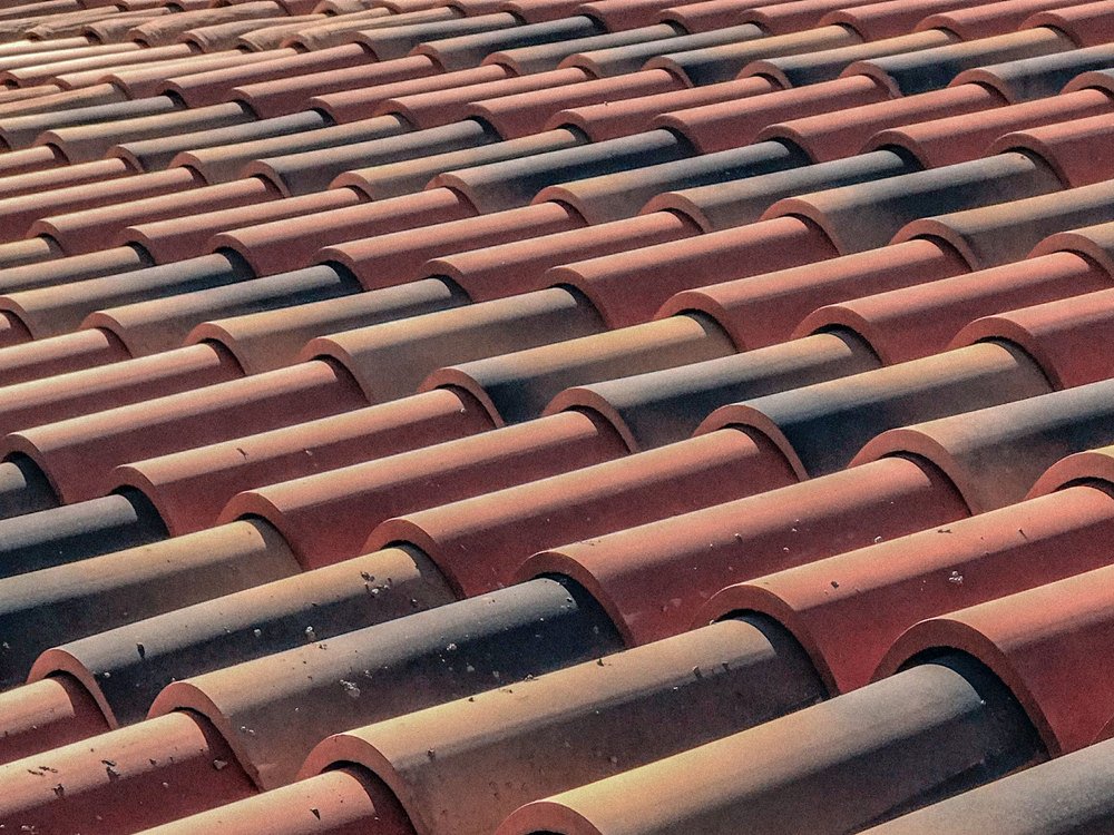 Rows of clay barrel tile in warm light