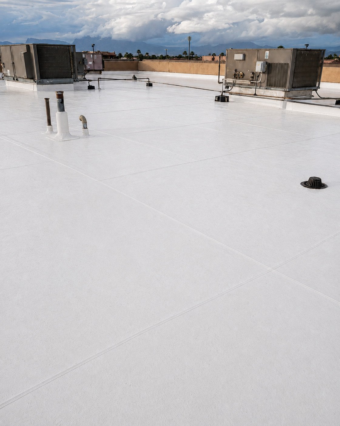 The same TPO roof after repair, the membrane flat and clean with the drain area sound